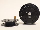 a reel and a spool on a white surface