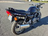 a motorcycle that is parked on the street in the parking lot
