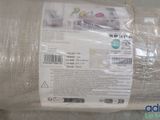 a roll of fabric wrapped in plastic on a table