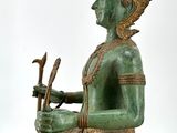 a statue of a man riding an elephant with a bird on its back