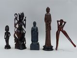 several wooden statues of different shapes and sizes on a white surface