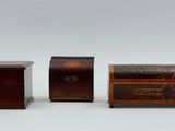 two small wooden chests sitting next to each other on a white surface