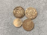 three british coins, one of which is a sovereign and one of which is a sovereign