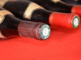 several bottles of wine are lined up on a red table