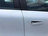 a dog sitting in the passenger seat of a car
