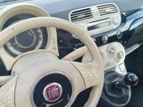 dashboard of a small car with a steering wheel and dashboard controls