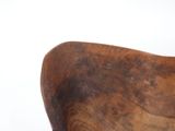 a wooden chair with a wooden seat on a white surface