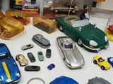 many different toy cars on a table with other toy cars