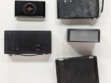 four different types of cameras on a white surface
