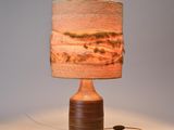 a lamp that is sitting on a table with a lamp shade on it