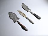 three different types of knives on a white surface