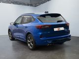 the rear end of a blue car in a showroom