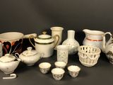 many different types of pottery on display on the table
