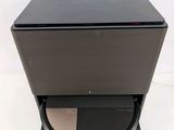 a close up of a black speaker on a stand with a white background