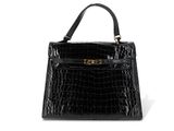un sac à main en cuir de crocodile noir sur fond blanc