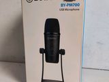 the box of a black microphone is sitting on a table