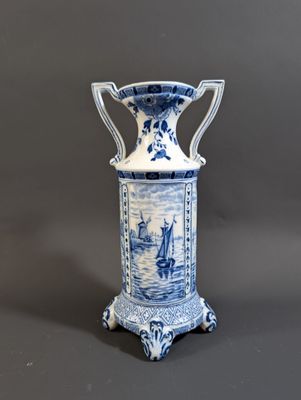 blue and white vase with a ship scene on it