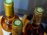 three bottles of wine sitting on a table next to each other