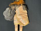 a doll that is hanging on the wall with a sword