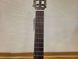 a close up of a guitar sitting on top of a hard wood floor