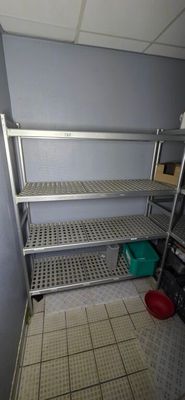 a metal shelf with shelves in the corner of a room