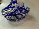 a small blue glass bowl sitting on a table