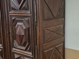 a large wooden cabinet in the corner of a room