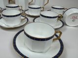 a lot of cups and saucers sitting on a table