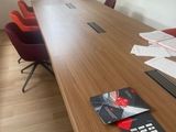 une longue table en bois sur laquelle est posée une télécommande