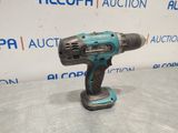 a cordless drill is shown on a table in front of a sign