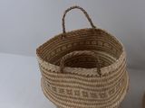 two baskets that are sitting on a white table