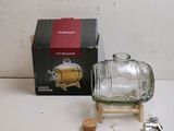 a small glass bottle with a cork stopper next to a box