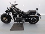 a black motorcycle that is parked in a room