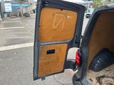 a van with the door open on the side of the road
