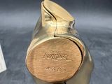 a gold figurine of a cat with a tag on it