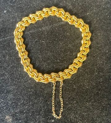 a gold chain bracelet with a heart charm on it