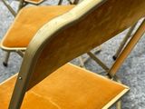 four chairs that are sitting in a row on the floor