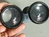 a person holding a pair of binoculars in their hand