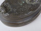 a bronze statue of a man and a dog on a base