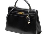 a black leather handbag on a white background