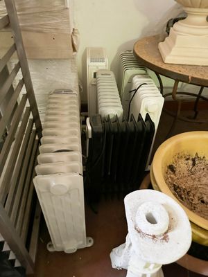 several rolls of toilet paper are sitting on a table next to a radiator