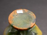 a close up of a vase with a tag on it