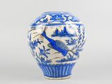 a blue and white vase with a bird on it