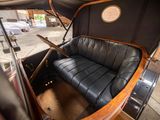 a black leather couch sitting in the back of a car