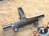 a close up of a metal pipe on a wooden surface