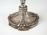 a silver candle holder on a white table