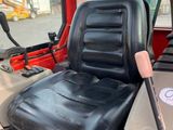 an image of a tractor seat with a baseball bat on it