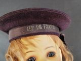 a close up of a doll with a hat on