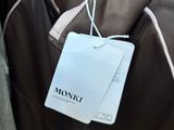 a brown jacket hanging on a hanger in a store