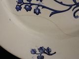 a blue and white plate with a bird on it